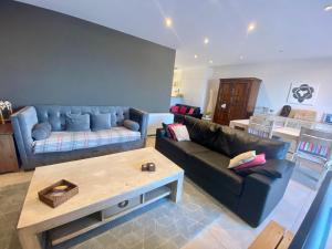a living room with a couch and a coffee table at Deluxe Apartment with Shared Pool in Ostend