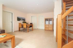 a living room with a table and a dining room at Ferienwohnung Kleekamp Norddeich in Norden