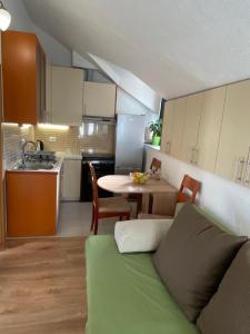a kitchen with a couch and a table in a room at Milea in Makarska