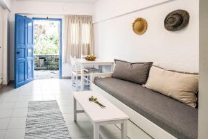 a living room with a couch and a table at Ninetta's Studios in Poros