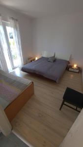 a bedroom with two beds and a large window at Apartments Porat in Porat