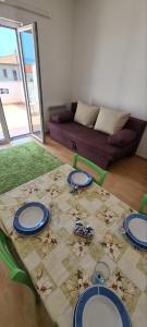 a table with plates on it in a living room at Apartments Porat in Porat