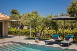 斯沃倫塔的住宿－Villa LAOURA，游泳池旁的两把椅子和一把遮阳伞