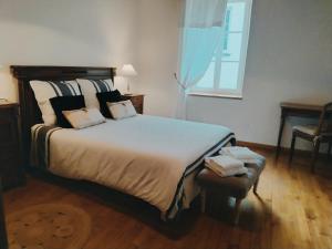 Säng eller sängar i ett rum på La maison d'iréne