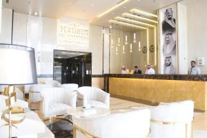a lobby of a restaurant with white chairs and a counter at Platinum Seventy in Jeddah