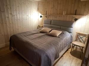 a bedroom with a bed and a chair at Gaustatoppen Lodge - Mountain View - Gaustablikk in Rjukan
