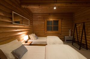 Posteľ alebo postele v izbe v ubytovaní Moiwa Lodge