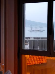 a ship in the ocean seen through a window at Apartamento Sanxenxo Carles Deluxe Ocean View in Sanxenxo