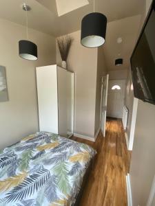 a bedroom with a bed and a television in it at Private room and bathroom with private entrance near Warwick town centre in Warwick
