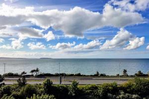 a view of the ocean on a cloudy day at Modern apartment with breathtaking sea views in Penmaen-mawr