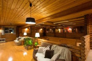 a living room with a couch and a wooden wall at Moiwa Lodge in Niseko