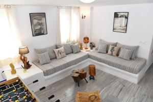 a living room with two couches and a pool table at Villa Angelica in Perivolos