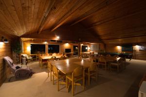 a restaurant with wooden ceilings and tables and a pool table at Moiwa Lodge in Niseko +41 photos