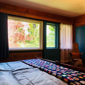A bed or beds in a room at Red Beech Cabin at Lake Bohinj & Triglav National Park