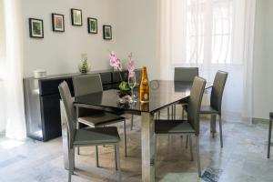 a dining room with a black table and chairs at Eirene Exclusive Apartment in Tropea