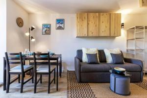 a living room with a couch and a table at Chic 2BR in city center, next to Train Station in Chamonix