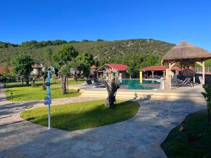 a park with a playground with a pool and a pavilion at Dachas Cove Hotel in Agva