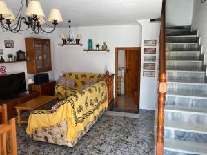 sala de estar con sofá y escalera en Duplex familiar, en Puerto de Mazarrón