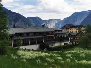 a group of buildings with mountains in the background at Pension Bergfried in Hallstatt
