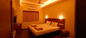 Postel nebo postele na pokoji v ubytování Hotel Rhythm Grand Suite
