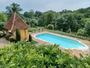 a swimming pool with a gazebo in a garden at LA VIGNERAIE in Albiac
