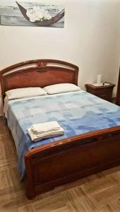 a bedroom with a bed with a blue comforter at Casa Crispi 10 in Gioiosa Marea