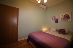 a bedroom with a bed and two pictures on the wall at Sääse Apartments in Pärnu