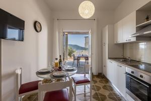 a kitchen and dining room with a table and chairs at Family Apartments Jadrijević in Primošten