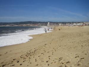 a group of people walking on a beach at Sport Hostel Figueira da Foz in Figueira da Foz +19 photos
