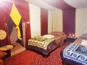 a bedroom with two beds in a room at Chigaga Luxury Camp in Mhamid
