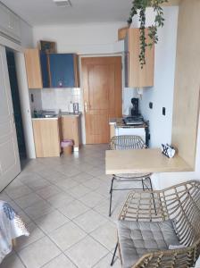 a living room with two chairs and a kitchen at Blue Lagoon Studio 2 in Mesolongion