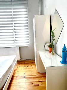 a bedroom with a bed and a desk with a mirror at Windrose Hostel Istanbul in Istanbul
