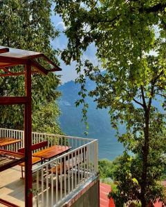 a balcony with a view of the mountains at The Whispering Oaks in Nainital