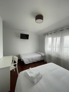 Posteľ alebo postele v izbe v ubytovaní Hostal Portofino