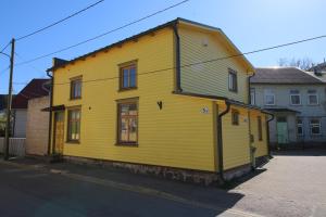 a yellow house on the side of a street at Sääse Apartments in Pärnu