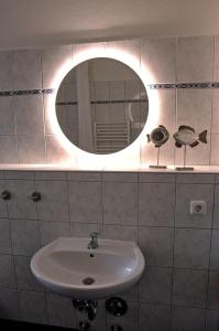 een badkamer met een wastafel en een spiegel bij Apartment in ruhiger Wohnlage Sie sind in 3 Minuten am Trebbower See oder in 30 Minuten an der Ostsee in Klein Trebbow
