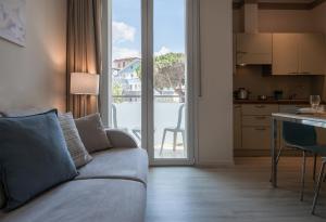 a living room with a couch and a kitchen at Residence Capitol in Cattolica