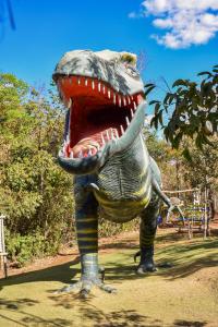 a statue of a dinosaur with its mouth open at Ecologic Ville Resort - Oficial in Caldas Novas +36 photos