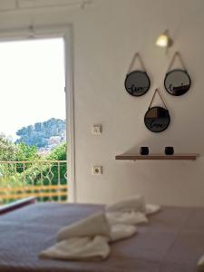 a bedroom with a bed with glasses on the wall at DANDOLOS STUDIOS in Parga