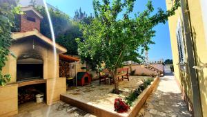 a patio with a tree and a building at SEA VIEW- spacious apartment with shared pool in Split