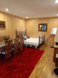 a room with two beds and a red rug at Agroturystyka Podlasie in Dobrzyniewo Duże