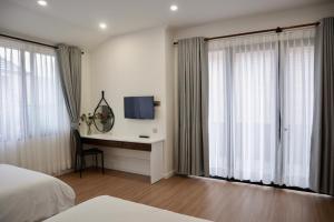 Postel nebo postele na pokoji v ubytování Hoang Loc Villa