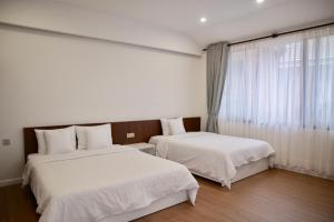 Postel nebo postele na pokoji v ubytování Hoang Loc Villa