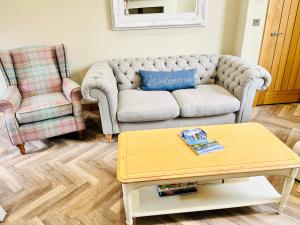 a living room with a couch and a coffee table at Ilkley House in Ilkley