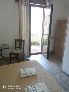 a bedroom with a bed and a door to a balcony at Bed & Breakfast Il Sentiero in Agerola