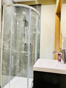 a bathroom with a shower and a sink at Ilkley House in Ilkley