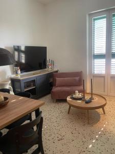 a living room with a couch and a coffee table at Apartament BellaPola Trapani in Trapani