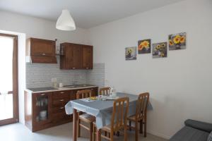 a kitchen with a table and some chairs and a table and a kitchen at SunFlower in Tenno