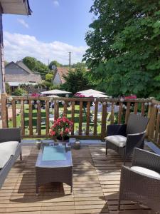 a patio with chairs and a table and a fence at Ma Campagne - Le Jardin in Auberville