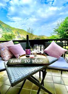 a table with a bottle of wine and glasses on a balcony at Ferienhaus Calmont in Bremm